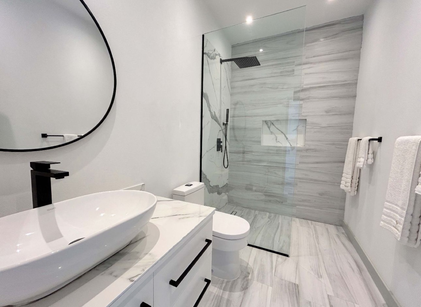Modern bathroom with a walk-in shower and white vanity