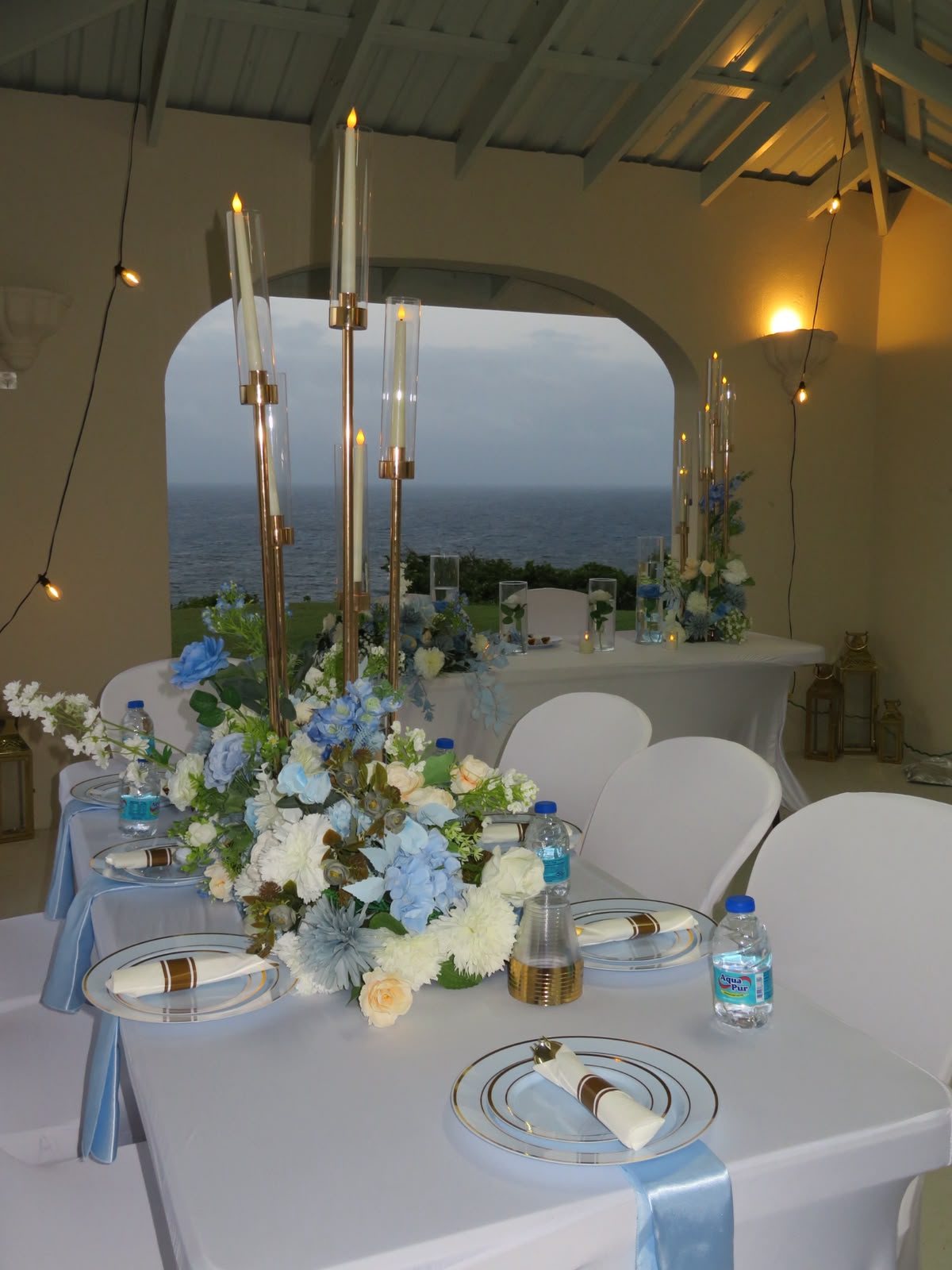 Candlelit event table beneath warm hanging lights