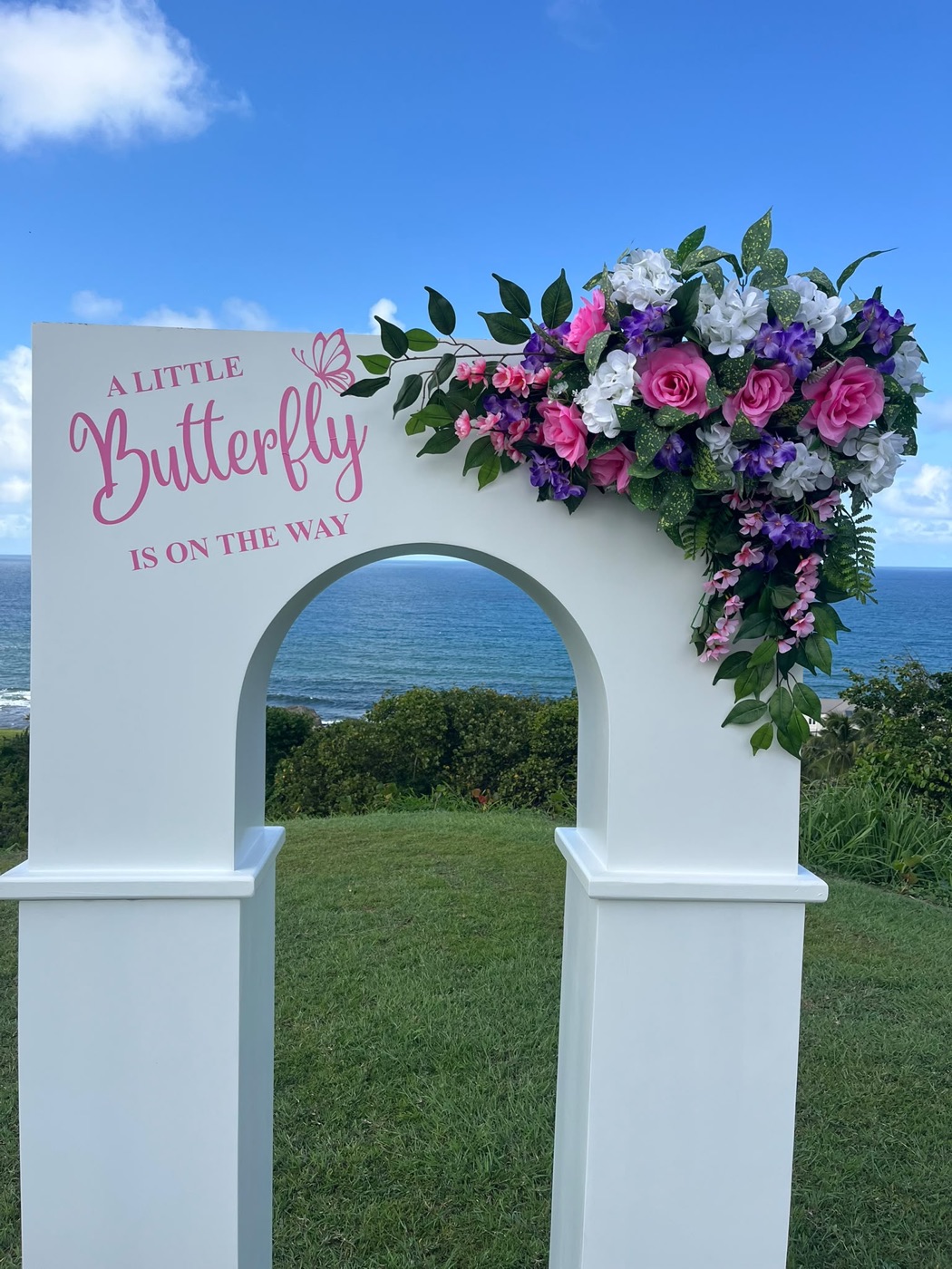 Floral celebration arch overlooking the sea